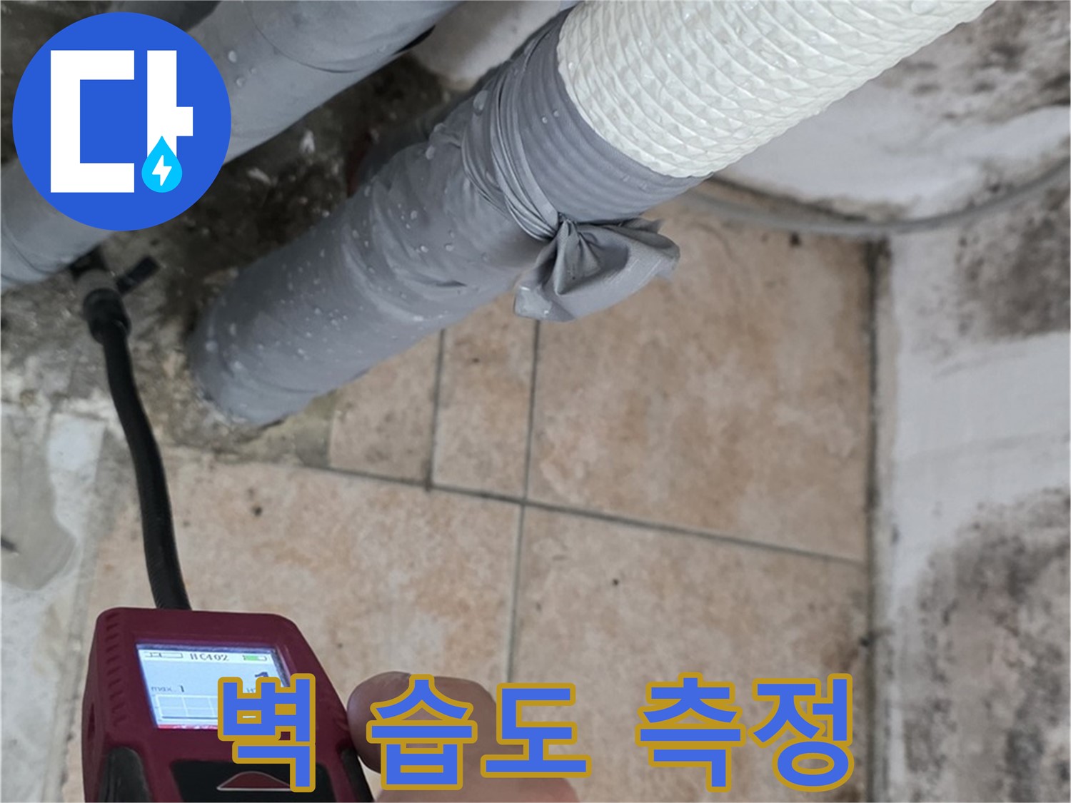 길음동 숭인로 누수 현장에서 첨단 습도 측정 장비로 벽의 습도를 측정하고 있습니다 - 정확한 누수 위치를 찾아드립니다.