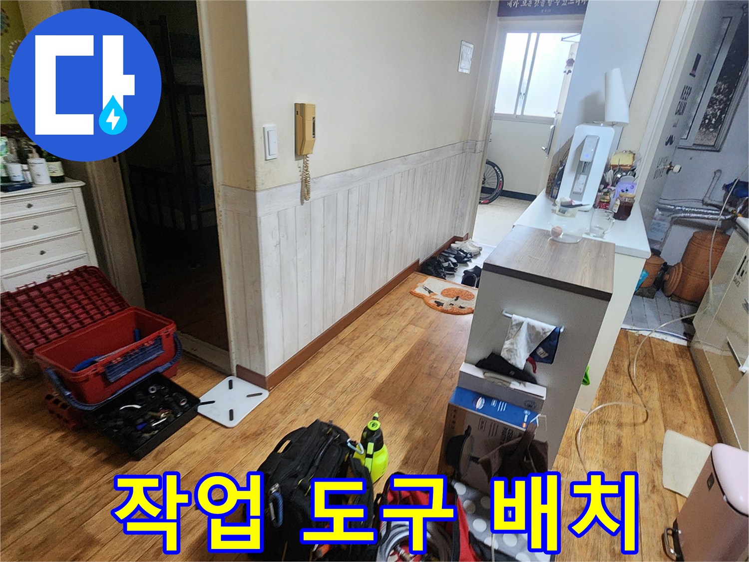 거실 바닥에 준비된 누수 탐지용 전문 장비와 배관 자재들