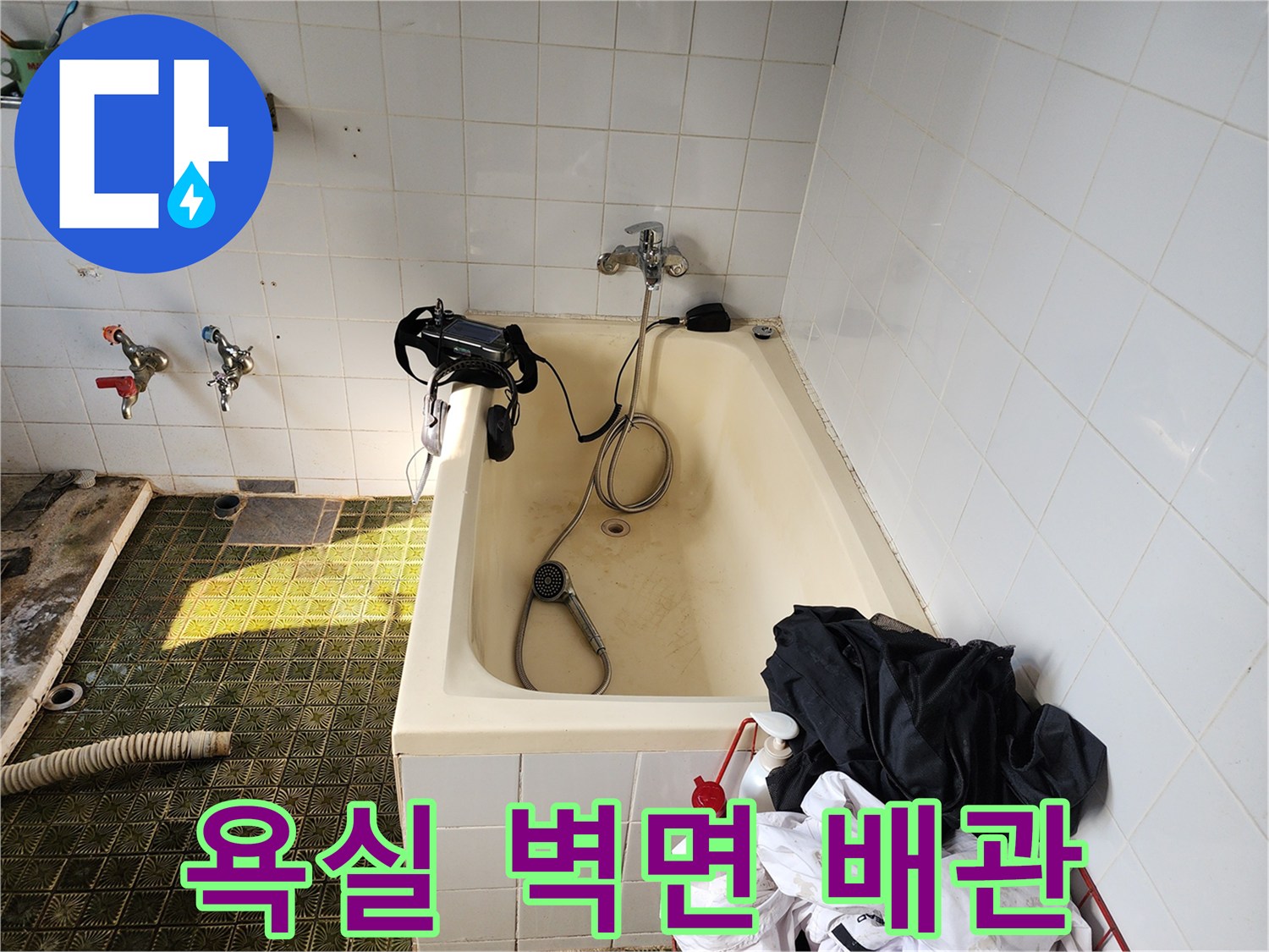 욕실 타일 벽면에 설치된 수전과 샤워기 헤드 근접 촬영