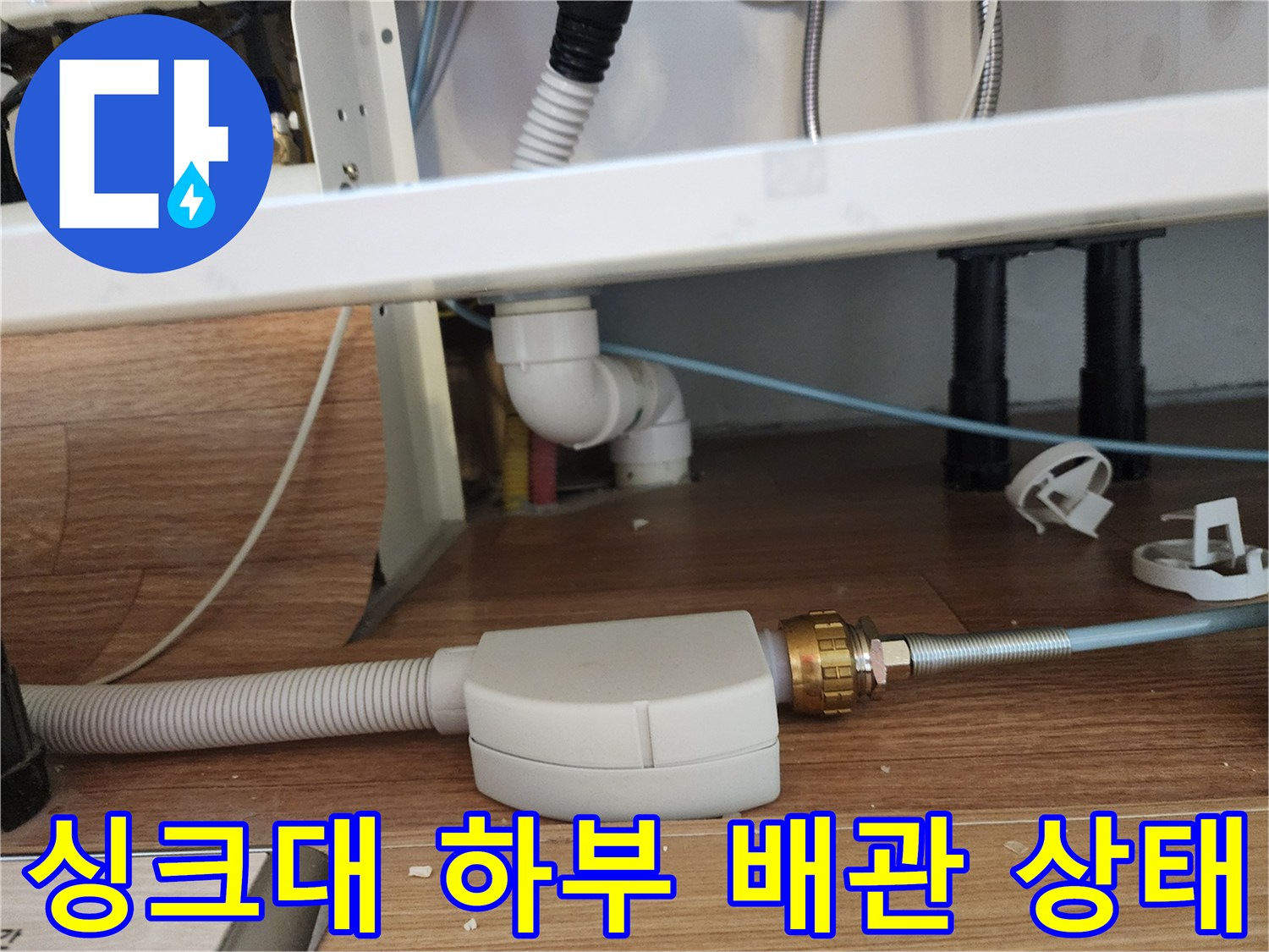싱크대 아래쪽 배관과 연결 부위를 가까이서 촬영한 모습입니다.