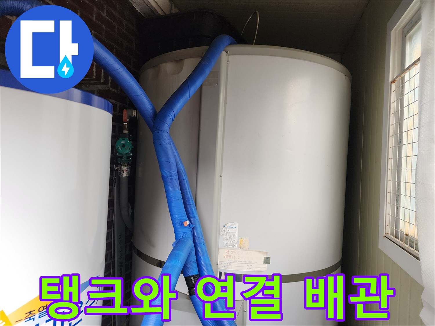 흰색 대형 탱크와 파란색으로 단열된 연결 배관의 모습입니다.