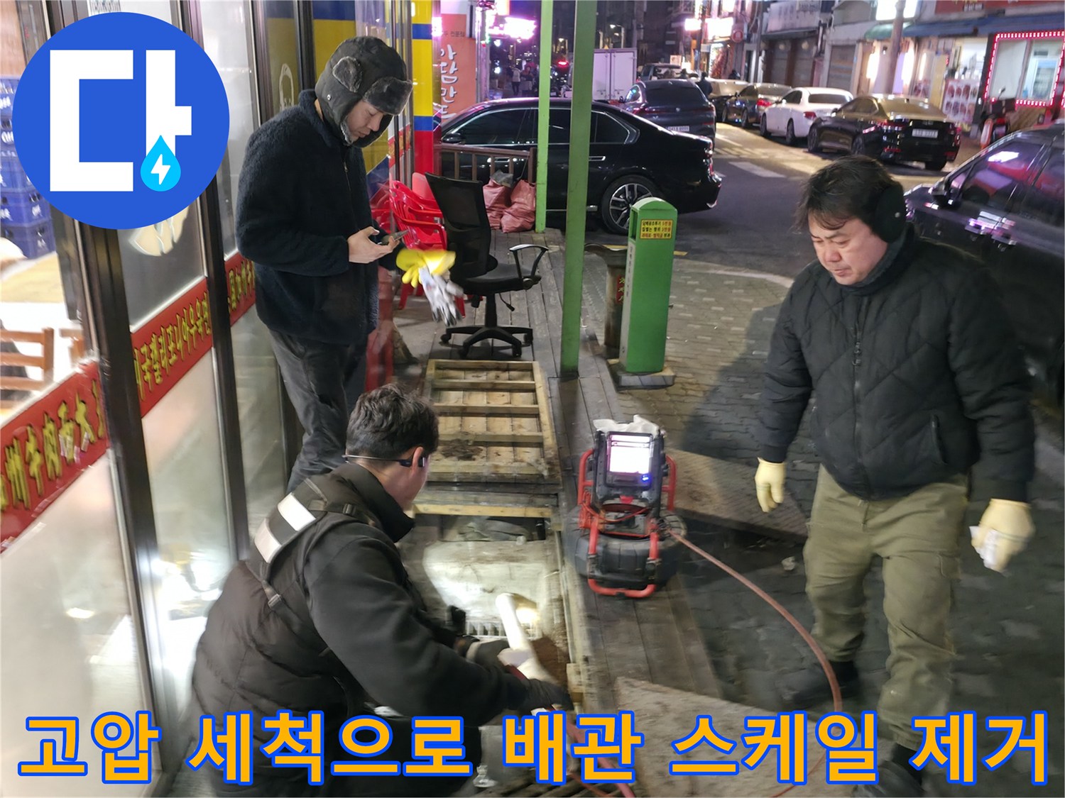 전문 장비를 활용해 식당 외부 메인 배수구의 이물질을 제거하는 공사 현장
