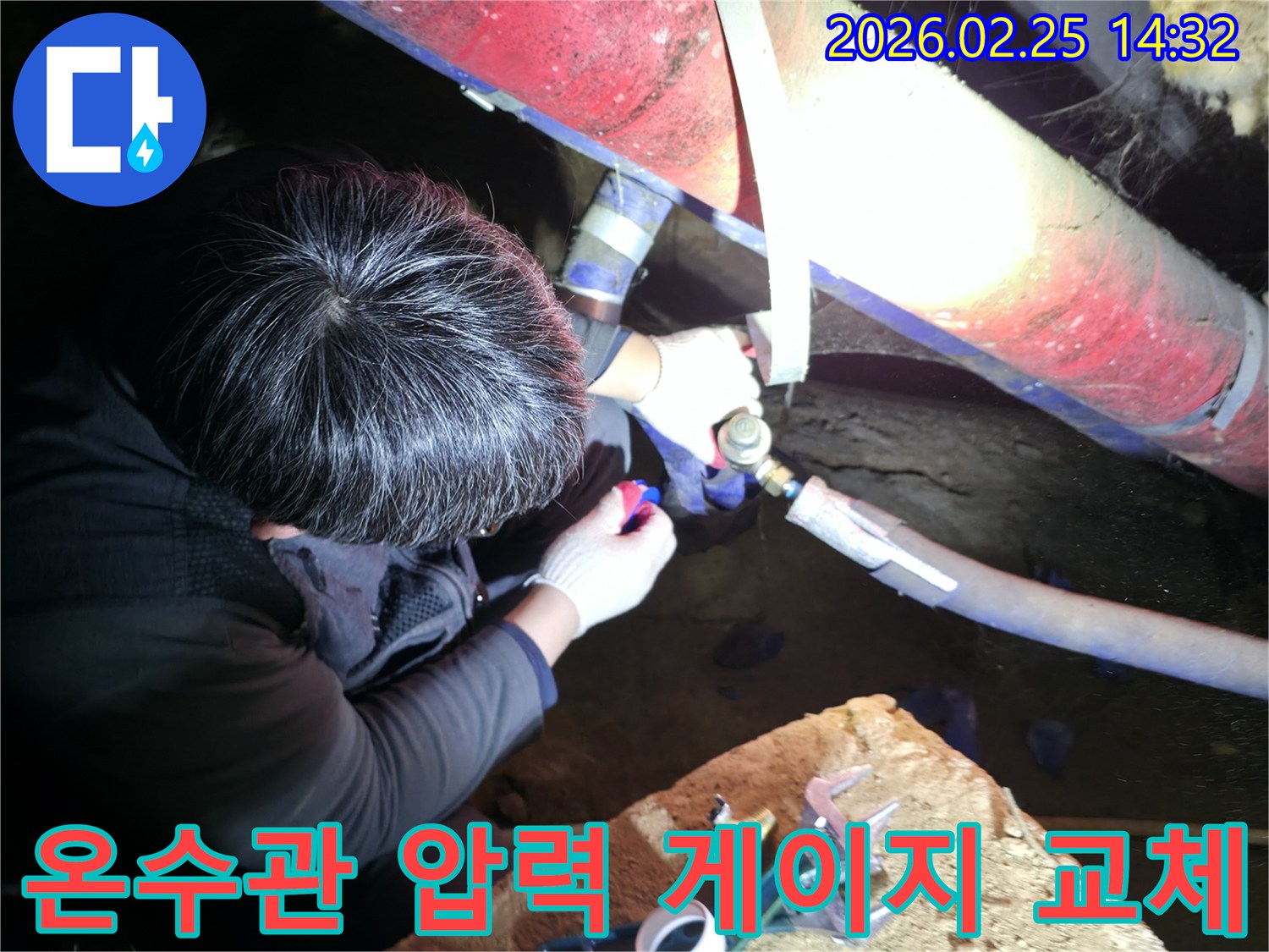 숙련된 누수 기술자가 좁은 공간에서 손전등을 비추며 온수관-압력 게이지를 정밀하게 점검하고-꼼꼼하게 교체하고 있습니다-온수누수해결-전문가수리