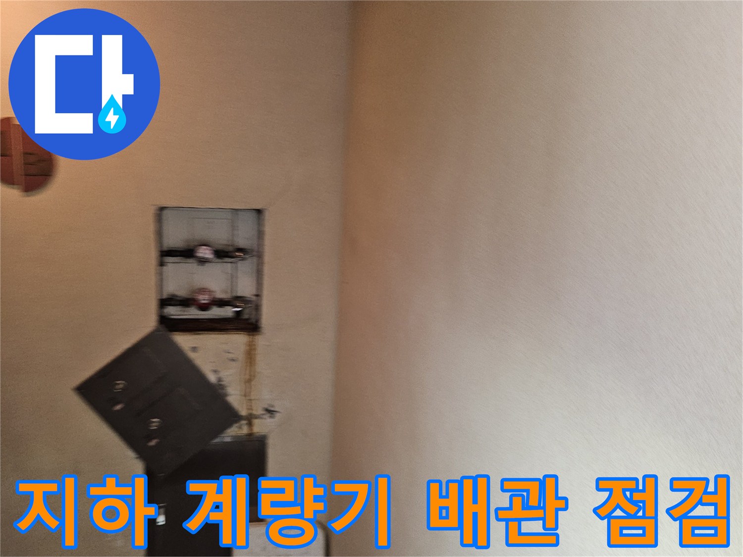 지하 천장에 설치된 수도 계량기와 연결 배관의 근접 촬영