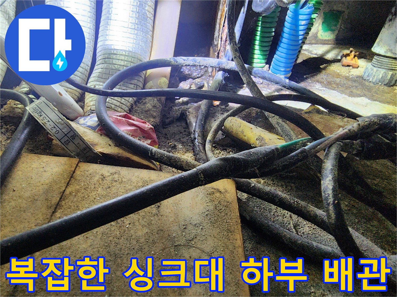 싱크대 아래 설치된 보일러 분배기와 연결된 다양한 규격의 배관들
