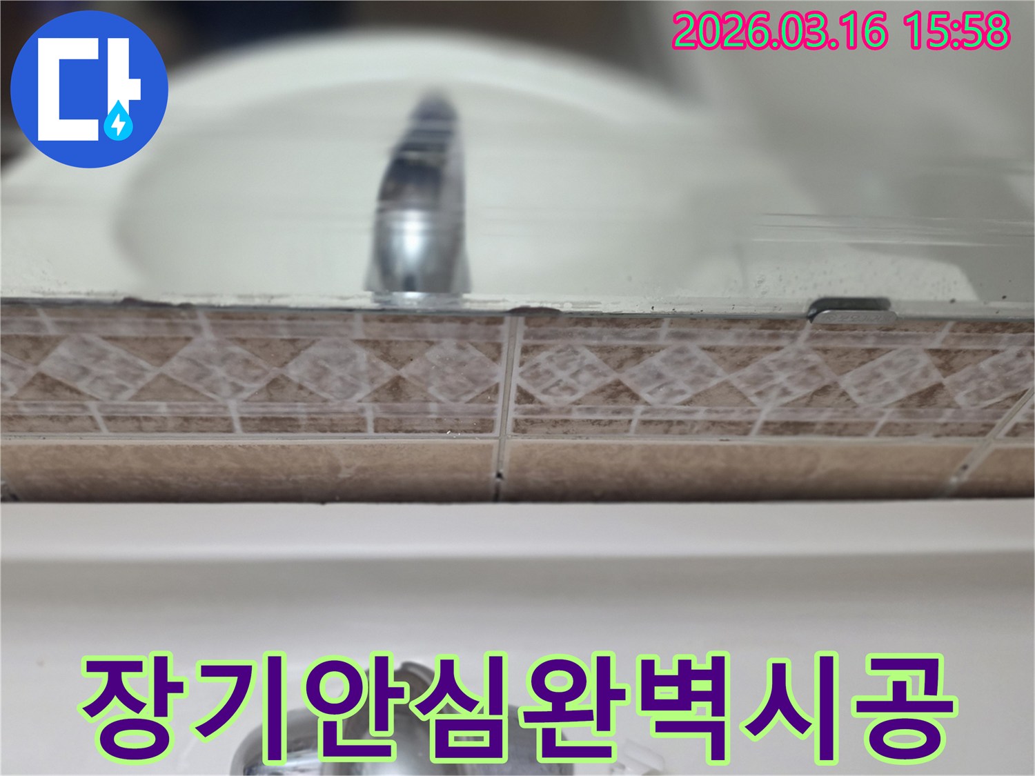 욕실-세면대-뒤-타일-틈새의-누수-흔적을-촬영하여-장기적인-안심을-위한-완벽한-누수-시공-과정을-설명하는-사진