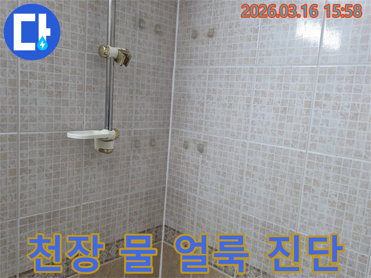 욕실 천장 타일에 누수로 인한 물 얼룩이 생긴-현장을 누수 전문가가 정밀 진단하는 모습