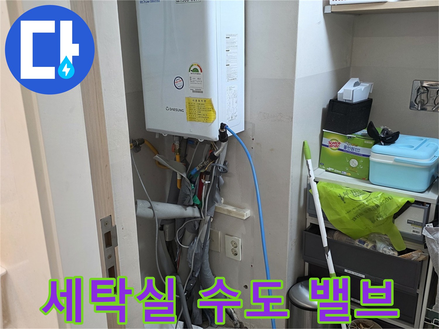 수도 밸브와 보일러 하단 배관이 노출된 세탁실 내부 사진