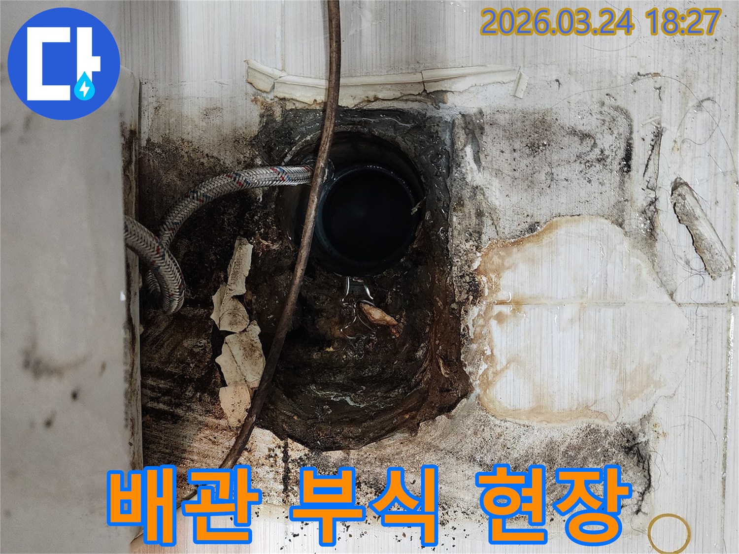오래된-배관-부식으로-인한-누수-현장에서-타일-제거-후-배관-상태를-점검하는-모습