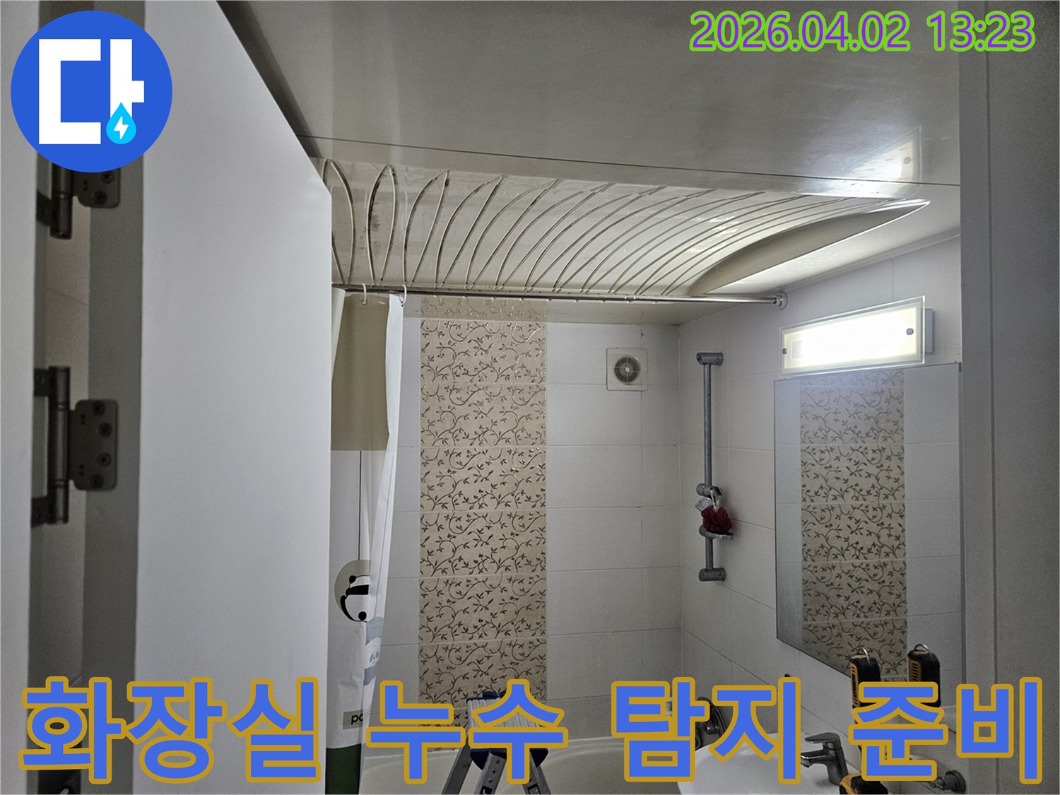 이 사진은-서울 양천구 목동의 주택 화장실에서-누수 탐지를 위한 준비 작업을 하는 모습으로-욕실 내부의 구조와-배관 상태를 확인하는-엔지니어의 세심한 접근을 보여줍니다.