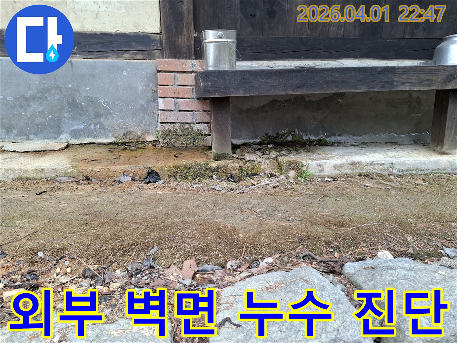 노후 주택의 외부 벽체에 나타난-습기 자국과-흙의 젖은 상태를 보여주는 진단 사진