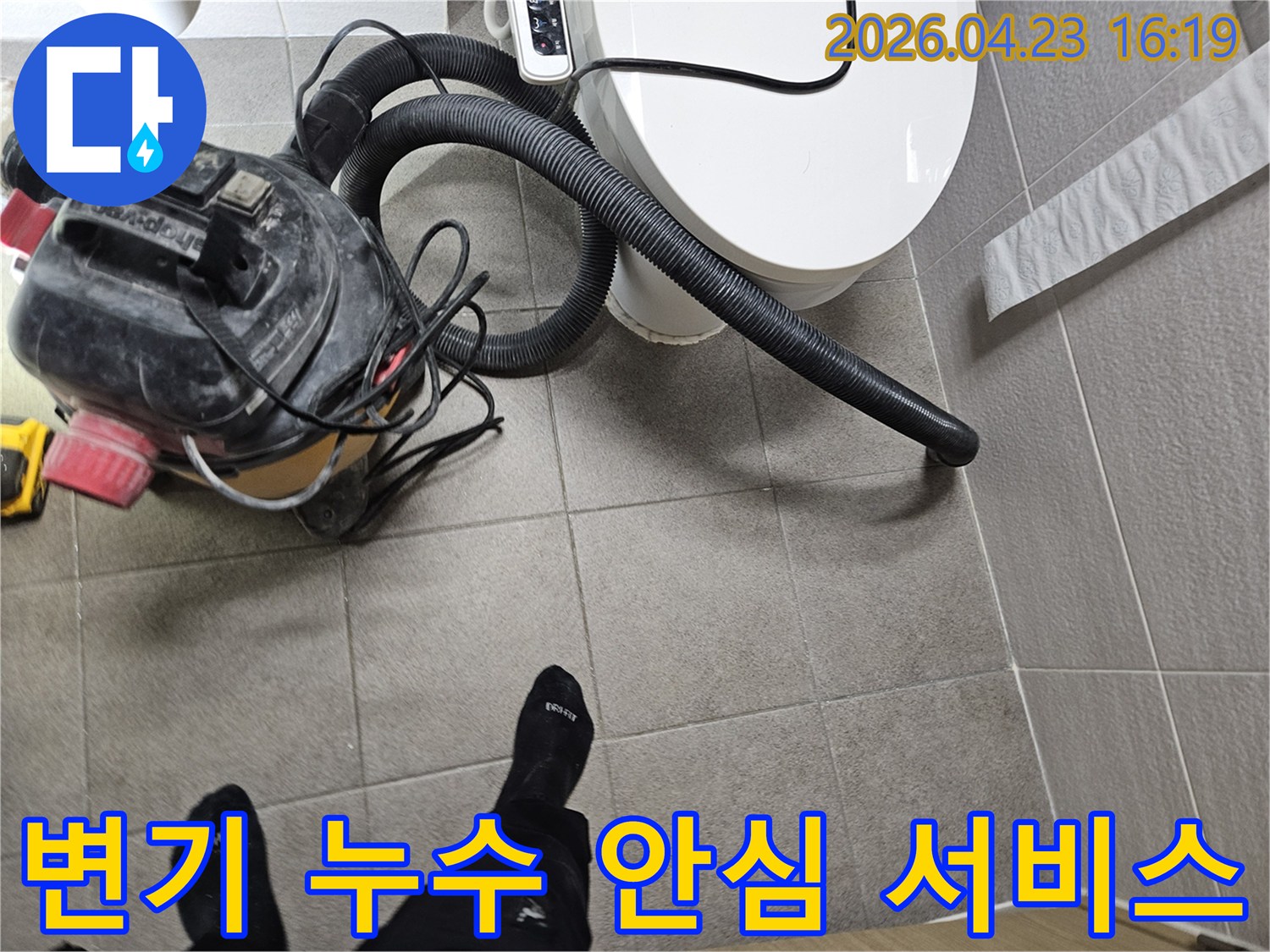 오산시 고객 댁 화장실에서-누수 엔지니어가-변기 주변의 물기를-습식 청소기로 제거하며-안심할 수 있는 서비스를 제공하는 모습