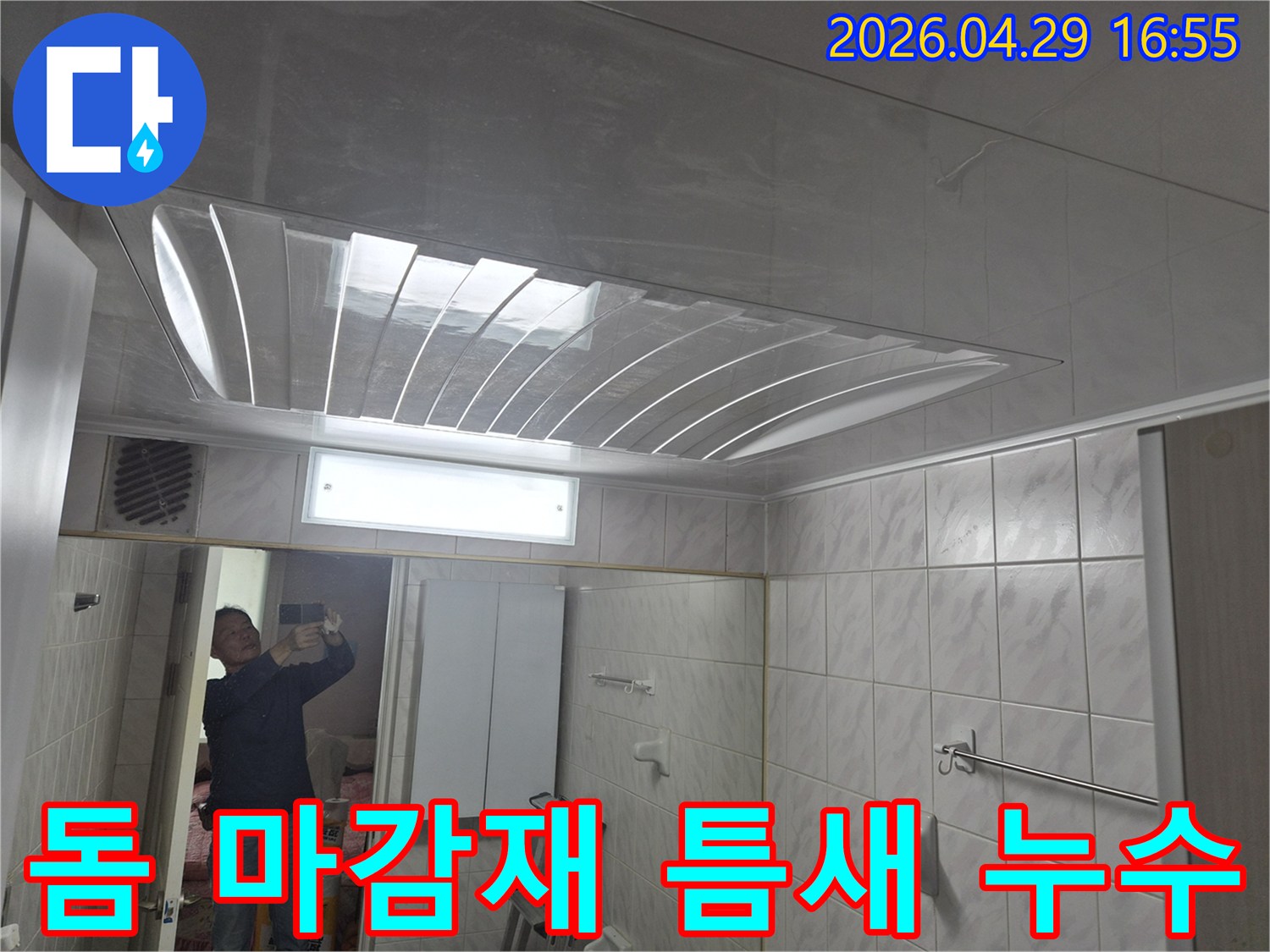 욕실-천장의-돔-형태-마감재와-조명-그리고-거울에-반사된-엔지니어의-모습이-담긴-누수-현장-점검-사진