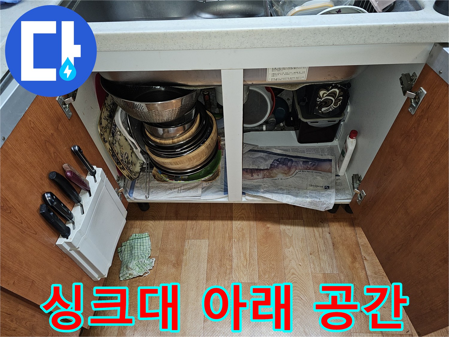 싱크대-하단부-내부의-정리된-용기들과-배수구