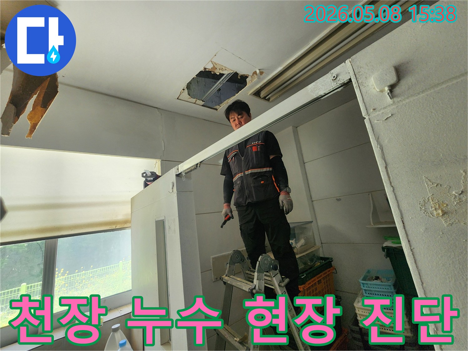 누수 엔지니어가 사다리 위에서-천장 손상 부위를-집중적으로 살피고 있습니다