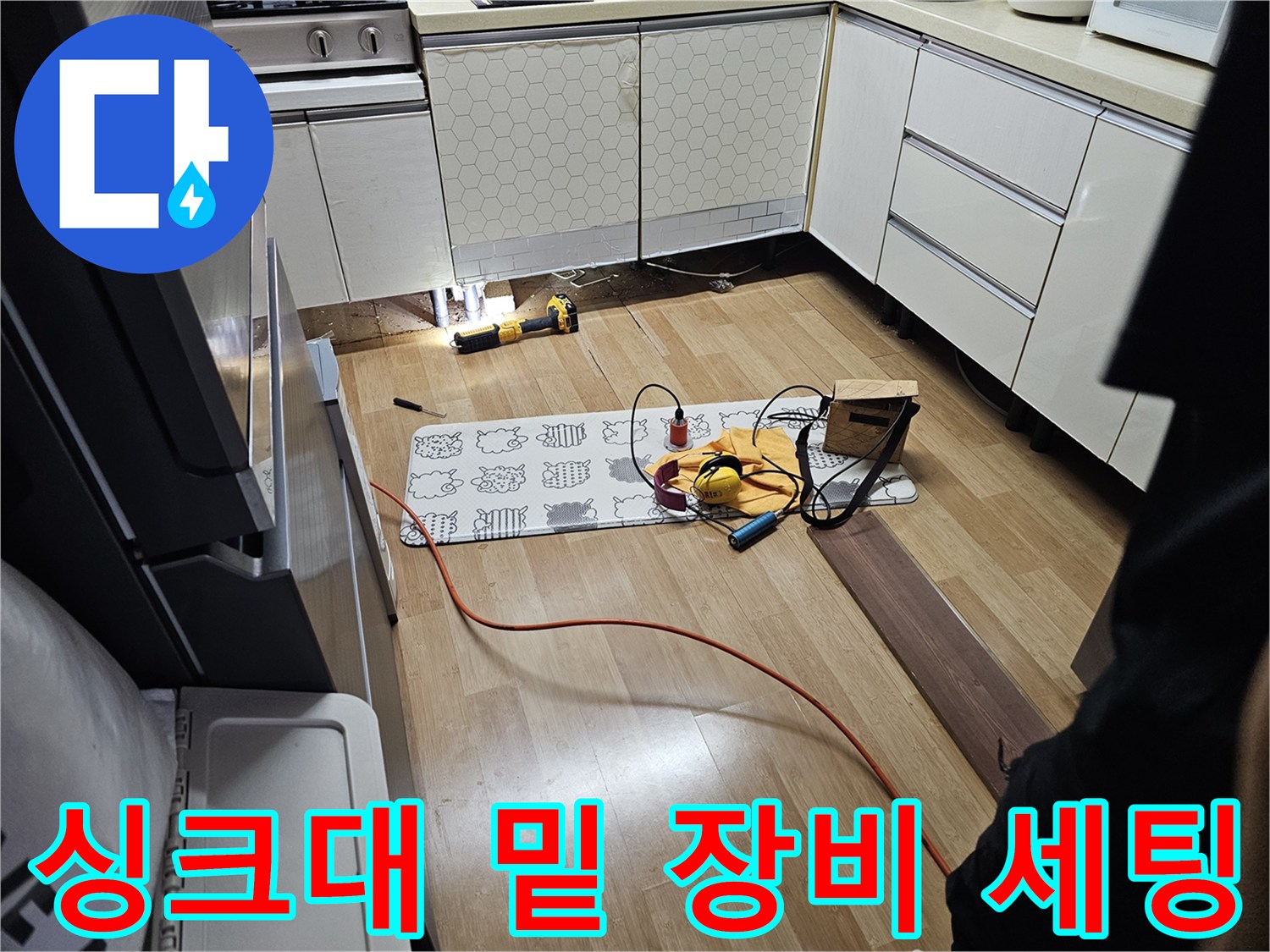싱크대 아래 바닥면의 누수를 진단하기 위해 준비된 공구와 탐지기