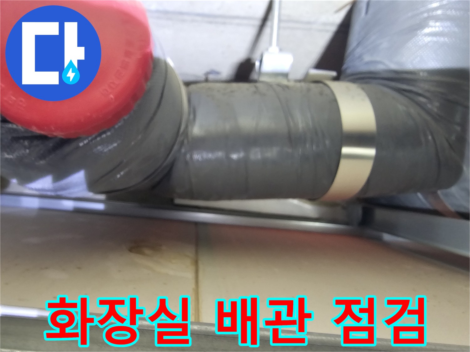 화장실 천장 내부의 검은색 보온재로 감싸진 하수배관 모습