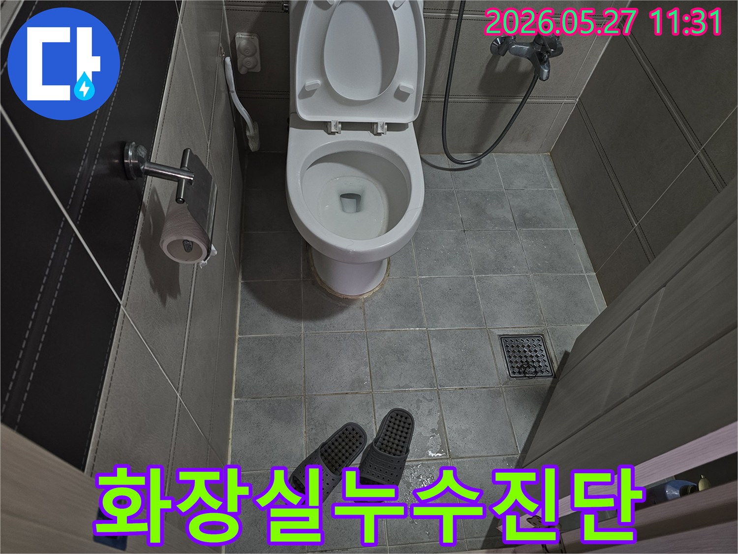 화장실-바닥-타일-위에-물이-고여있고-슬리퍼가-놓여있는-누수-현장-사진