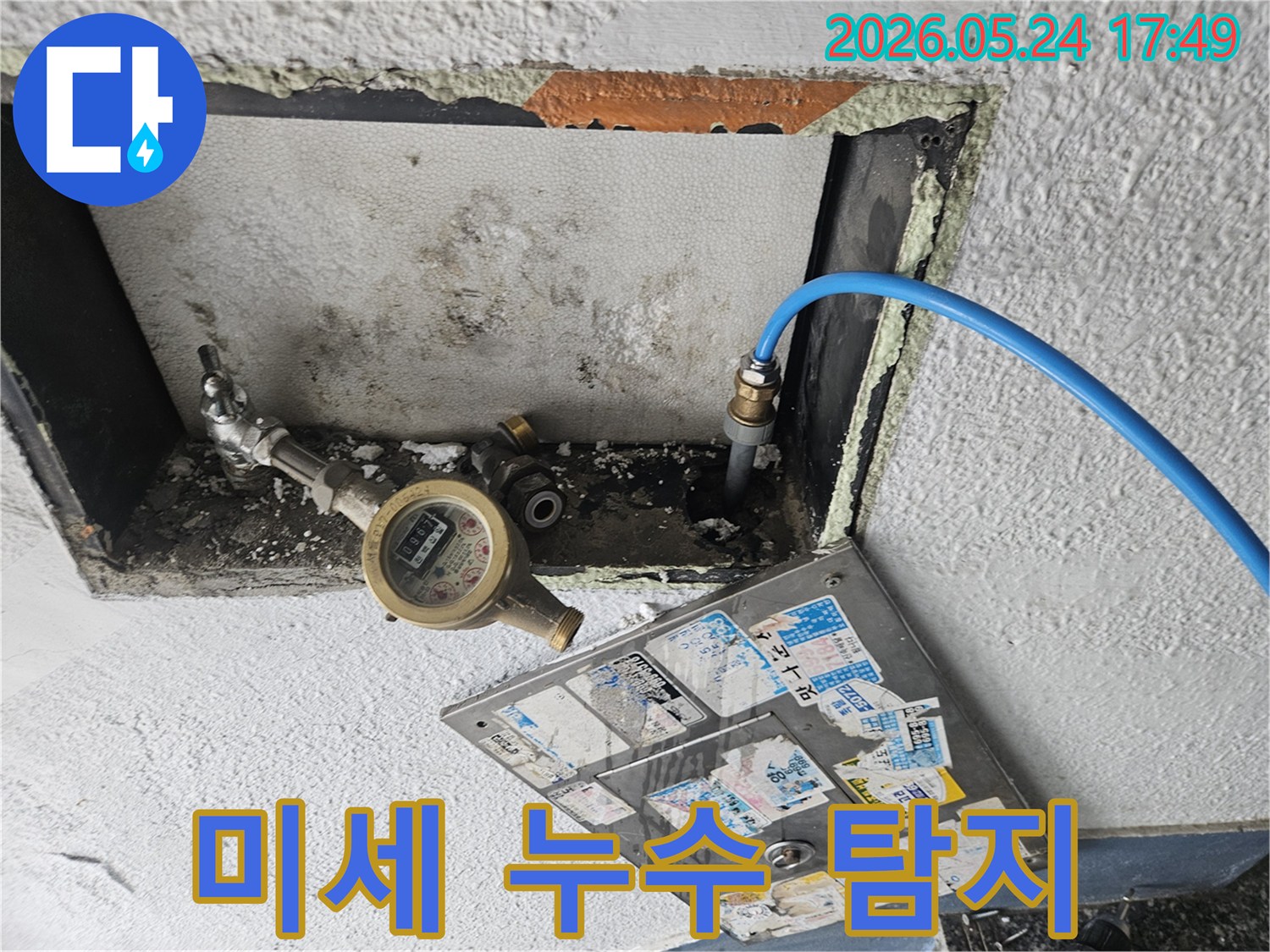 주택 미세 누수 해결을 위해 수도 계량기에 압력 테스트 장비를 연결하는 모습-정밀 탐지로 숨겨진 문제를 찾아 해결합니다