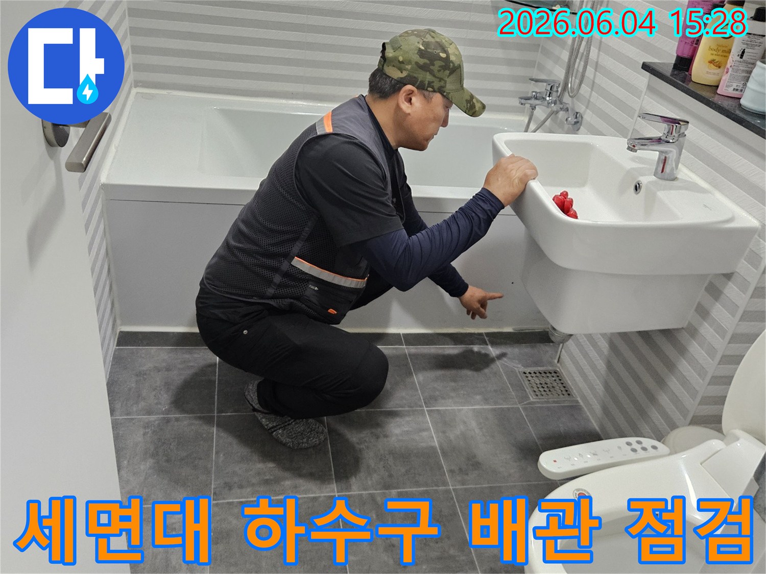 전문 엔지니어가-목동 월드아파트 욕실의-세면대 하수구 배관을-정밀하게 점검하여-누수 원인을 파악하고 있습니다