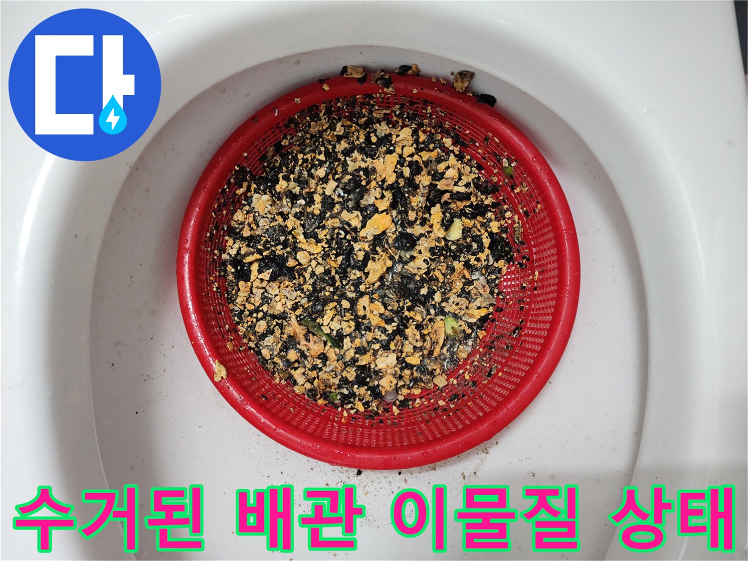 빨간색 채에 걸러진 배관 내부 슬러지 조각들