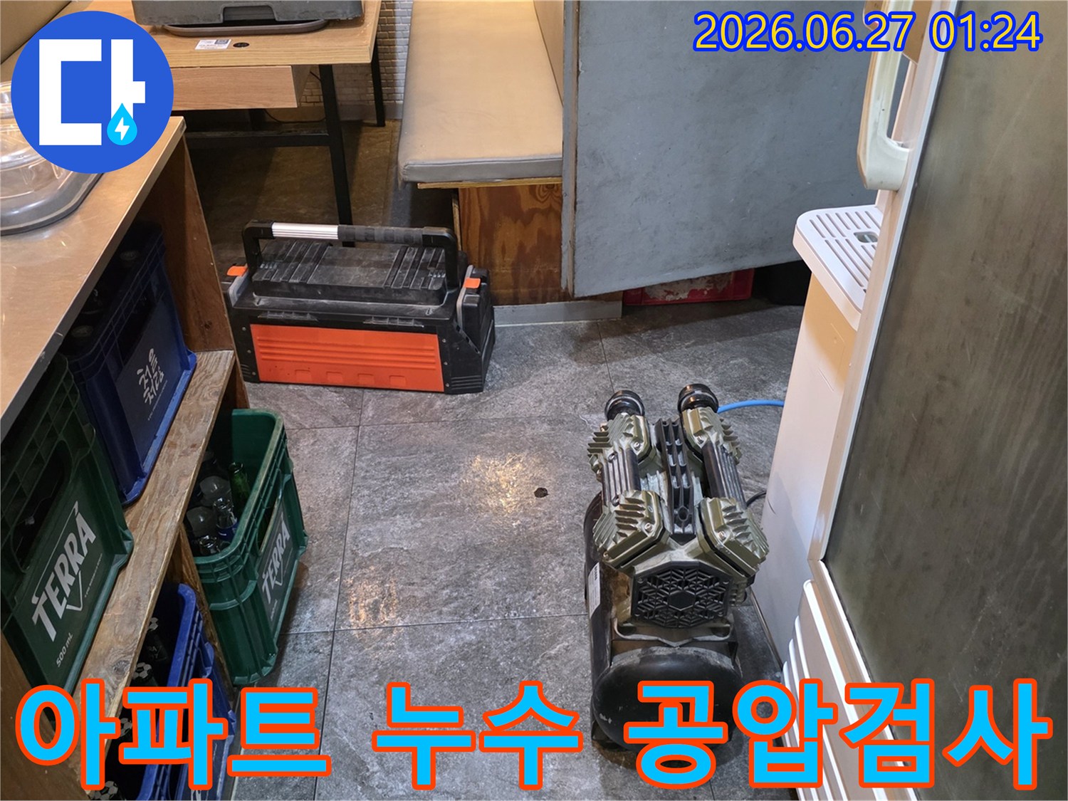 아파트 누수 탐지를 위해 공압 검사 장비를 설치하는 장면입니다-배관의 압력을 정밀하게 측정하여 누수 지점을 찾아냅니다