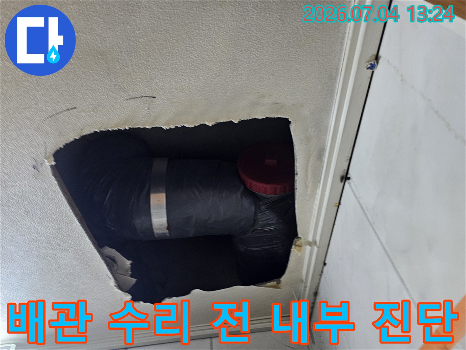 천장 점검구를 통해 드러난 배관 단열재와 연결 부속의 상세 이미지