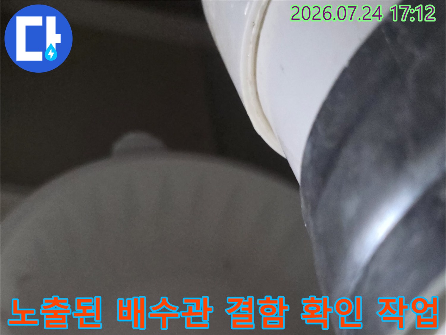 배수구 내부의 파손되거나 틈이 생긴 배관 연결 부위를 상세히 점검하는 장면