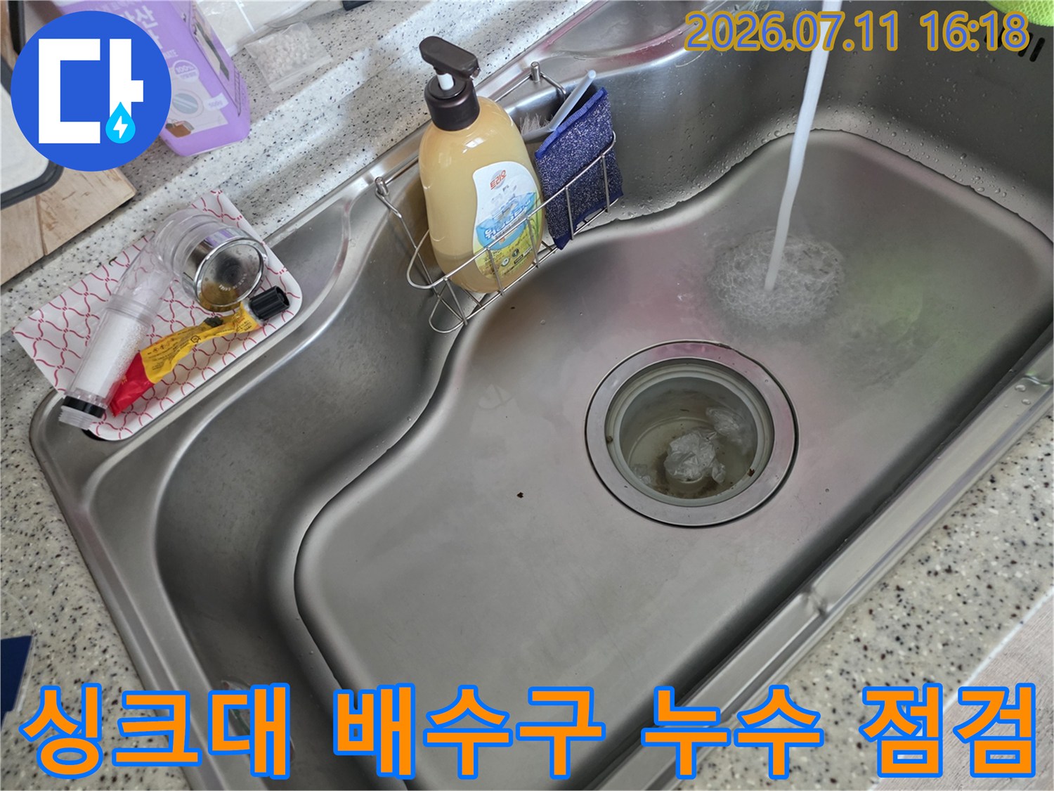 스테인리스 싱크대에서 물이 나오는 장면과 배수구 구조물