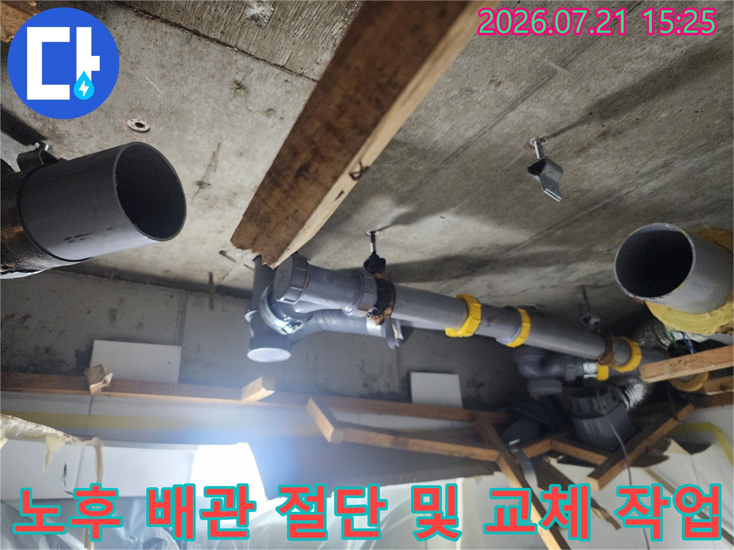 천장 내부에 노출된 오수 파이프의 누수 지점을 찾아 수리하는 현장 사진입니다.
