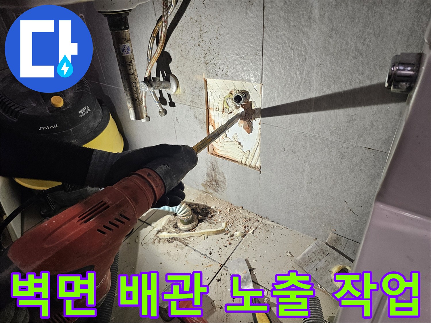 타일 굴착 후 드러난 벽면 배관의 연결 부위 상태를 점검하고 있습니다.