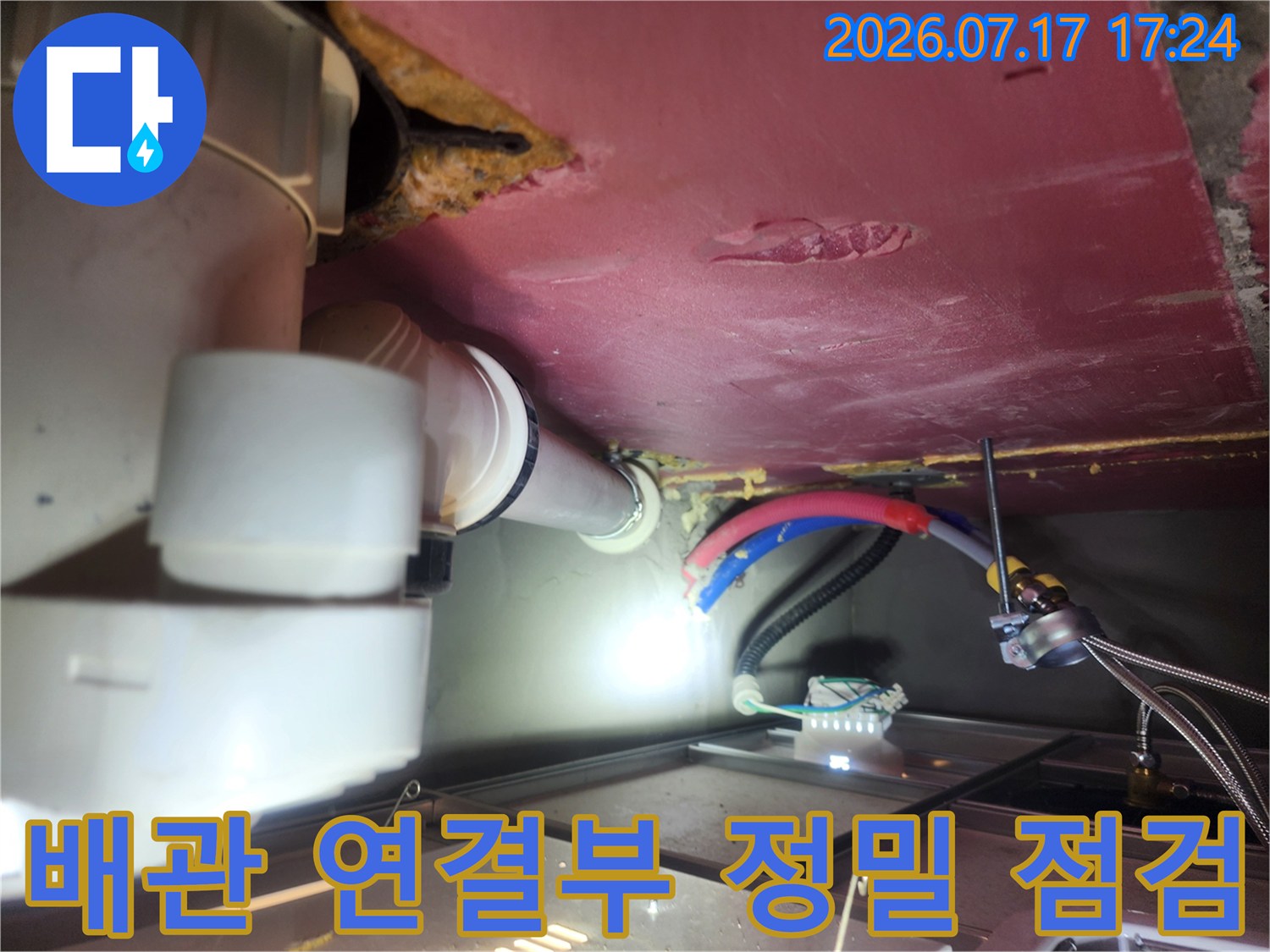 천장 안쪽 배관 연결 부위의 누수 여부를 확인하는 현장 사진