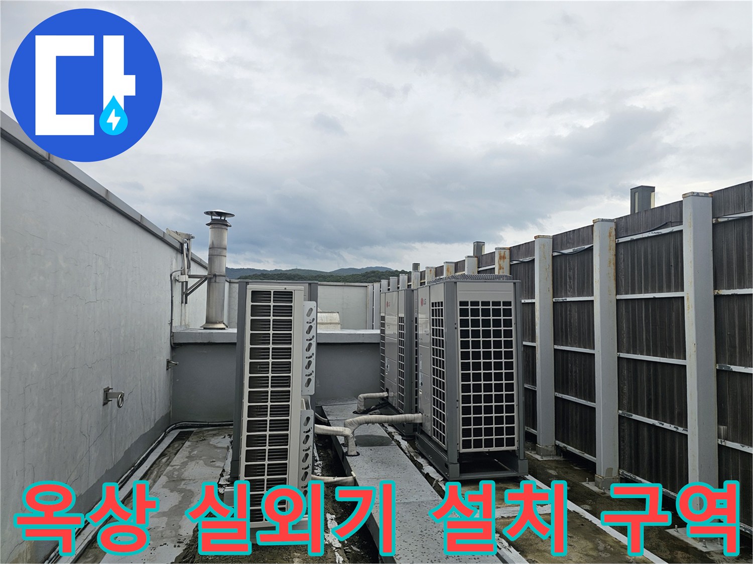 건물 옥상의 실외기와 배관 시설물이 위치한 환경을 보여줍니다.