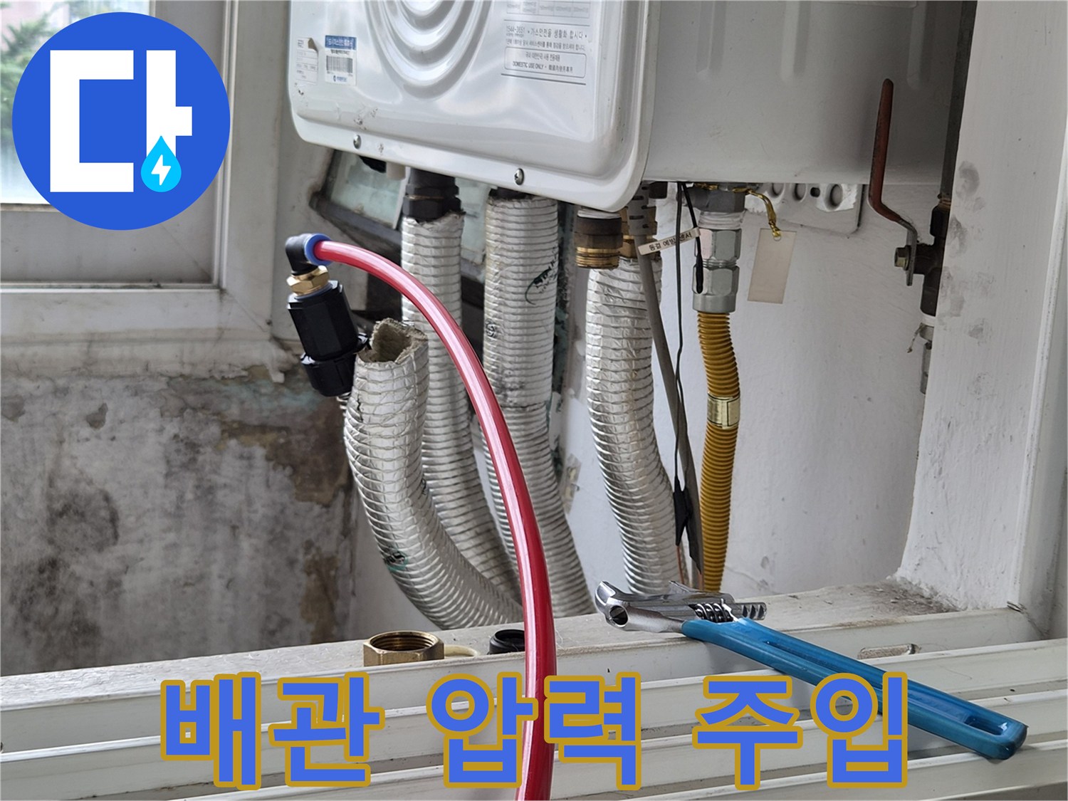 검사 중인 배관-붉은색 호스와 작업 도구의 모습