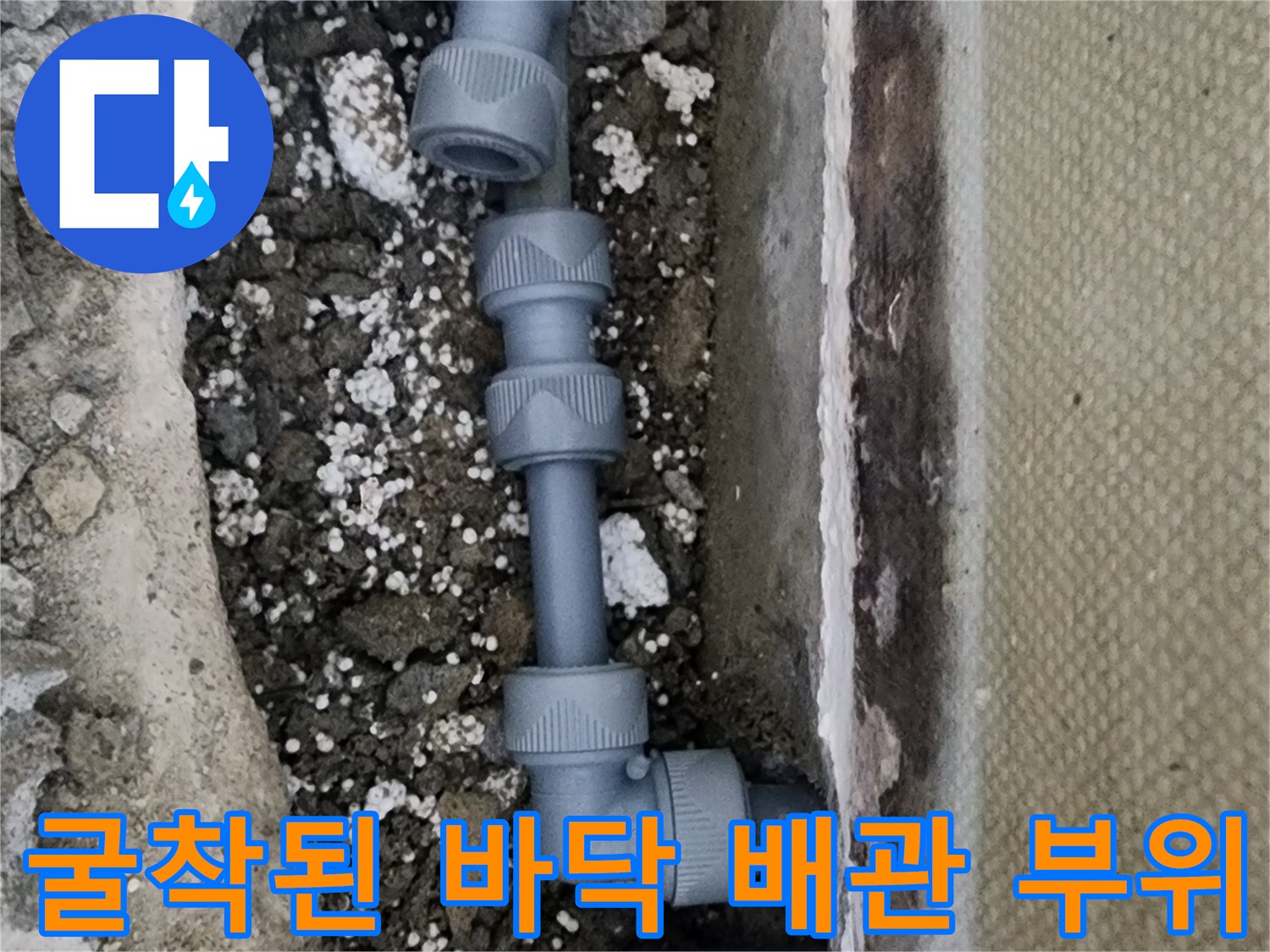 콘크리트 굴착 부위 내부에 노출된 회색 플라스틱 배관 연결 상태