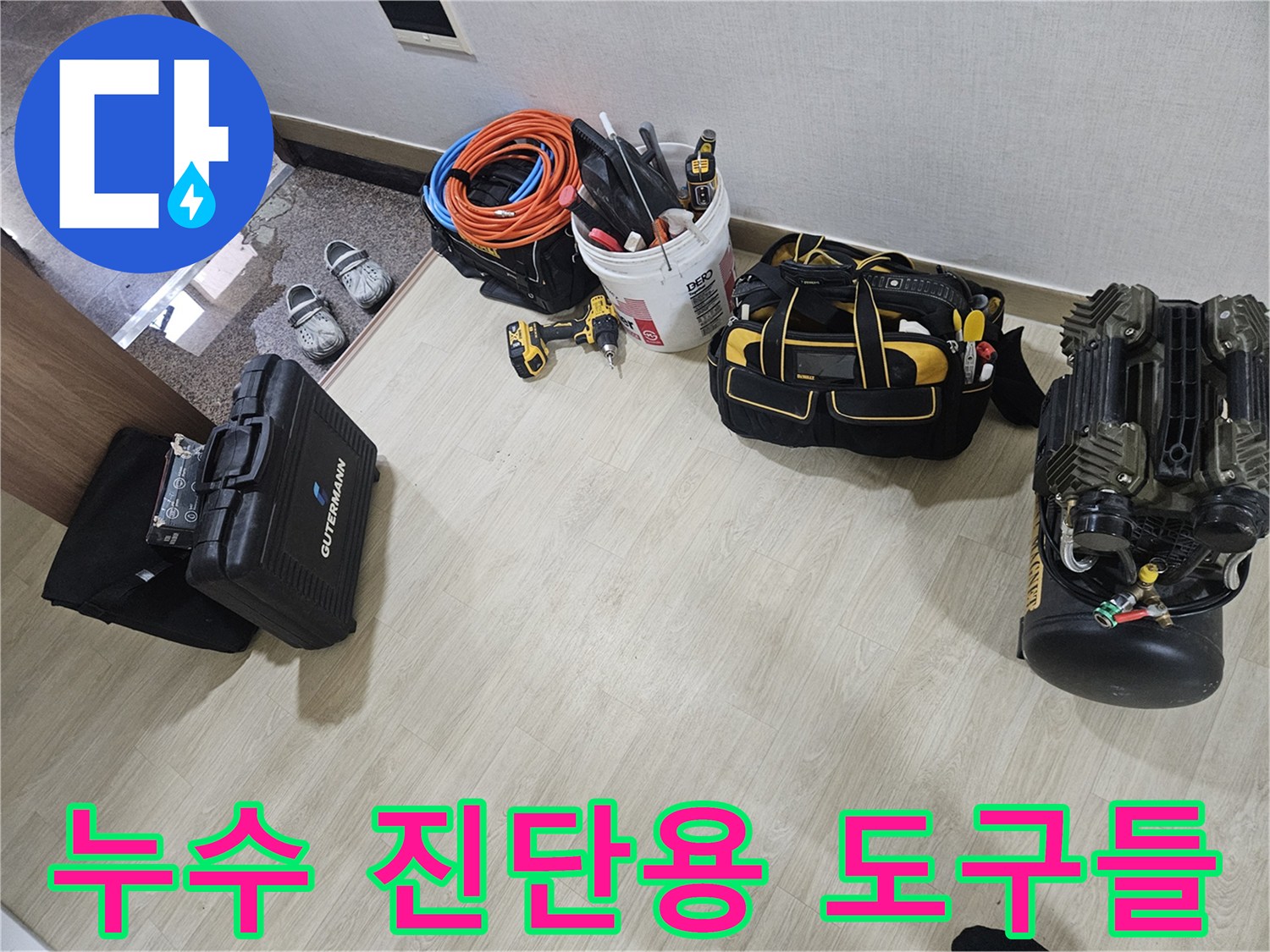 바닥에 나열된 누수 탐지용 에어 호스와 압력계 장비