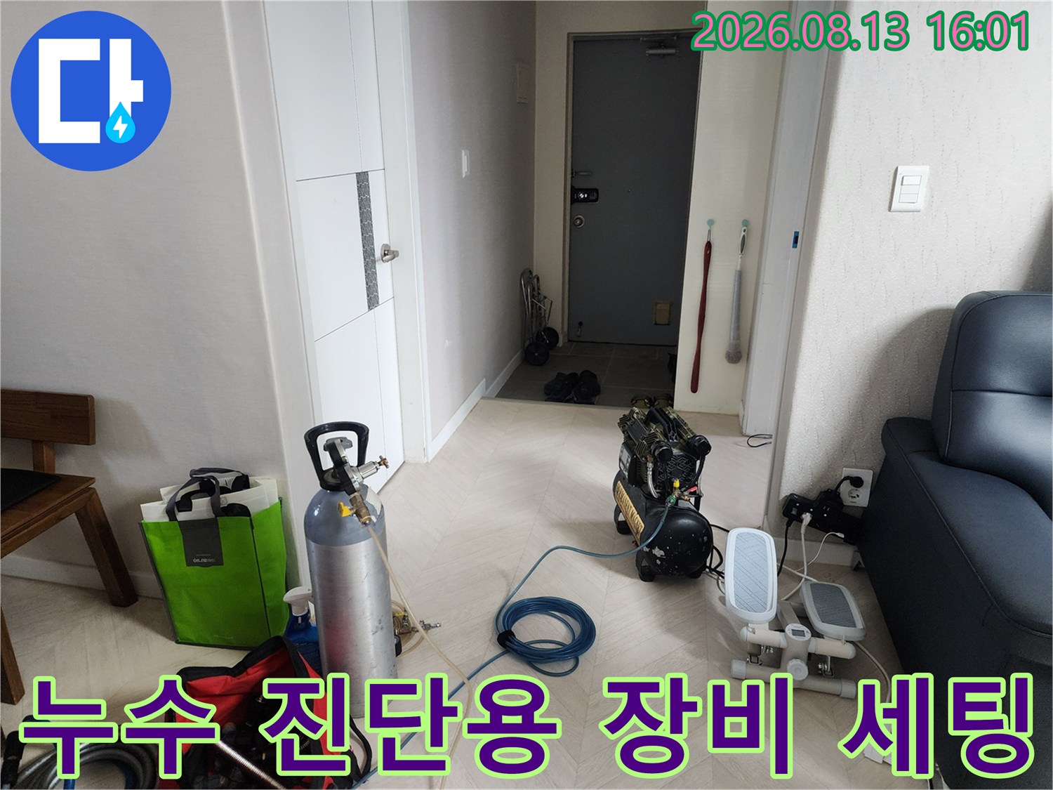 아파트 거실에 준비된 누수 탐지용 가스통과 압축기 장비