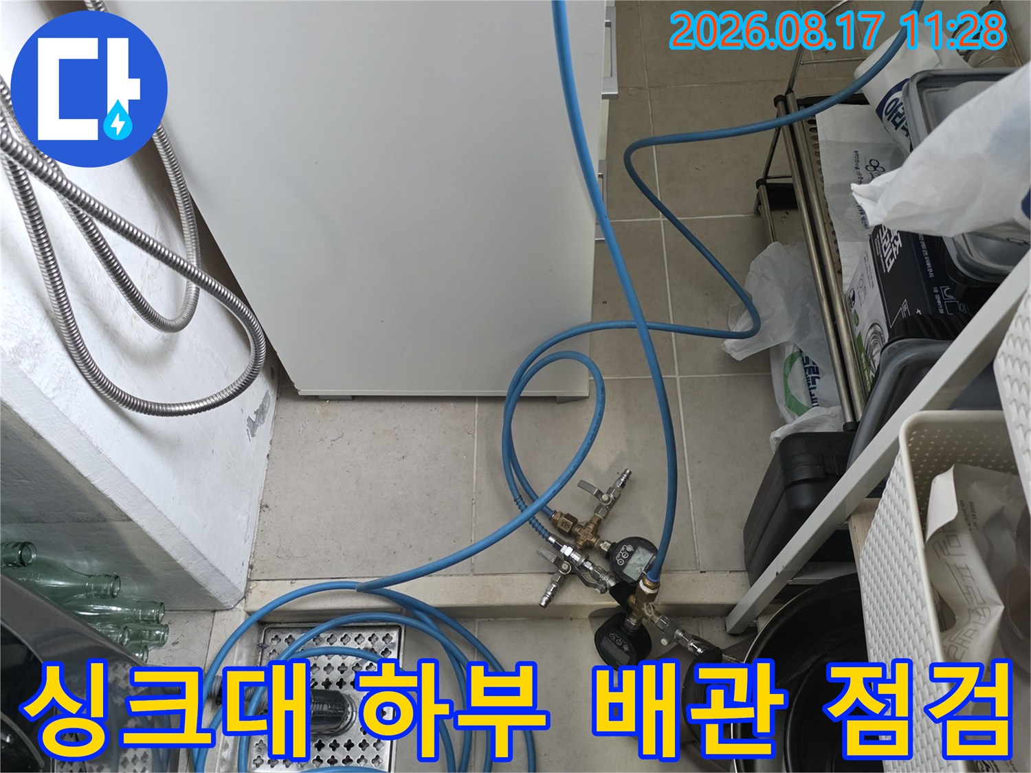 춘천 거두리 주방 싱크대 하부의 배관과 공압 검사 장비 모습