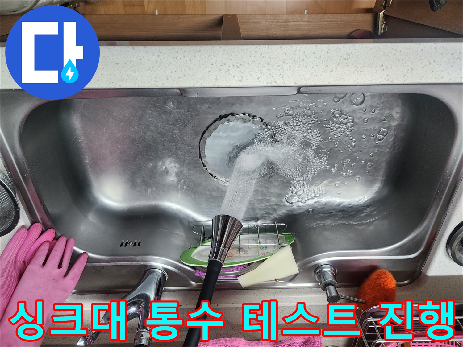 싱크대 배수구로 물이 흘러 들어가는 모습 - 누수 확인 중