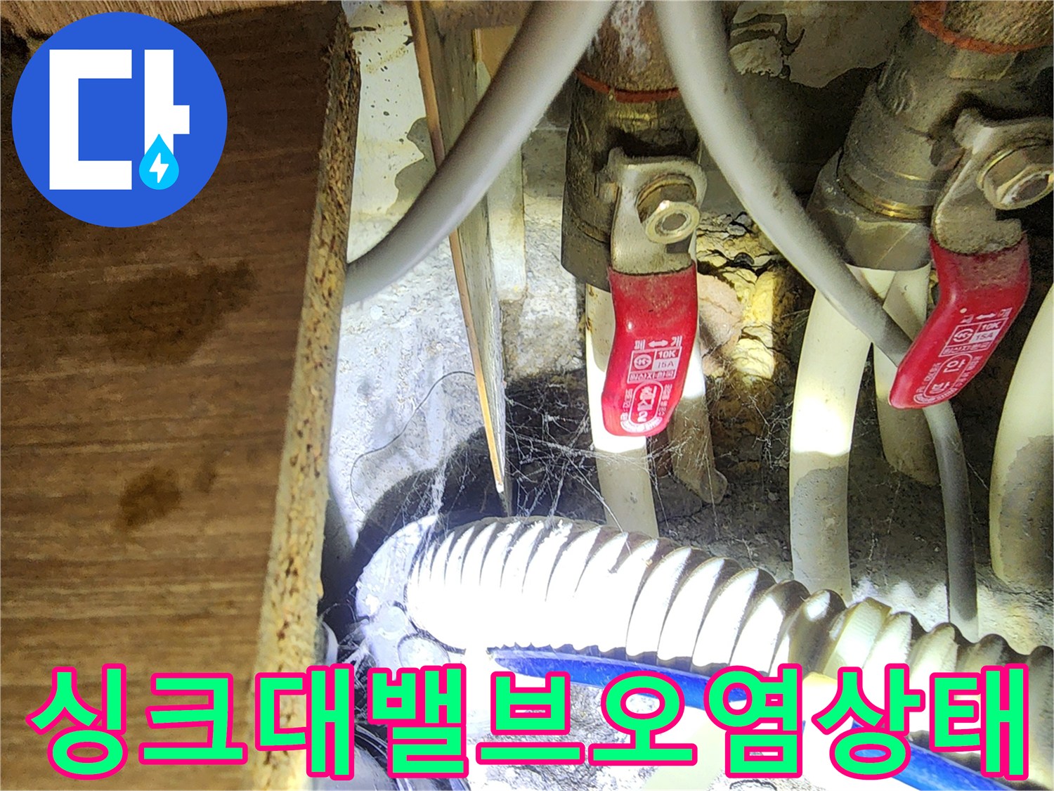 싱크대 밸브와 호스 주변의 오염물과 습기가 확인되는 사진입니다.