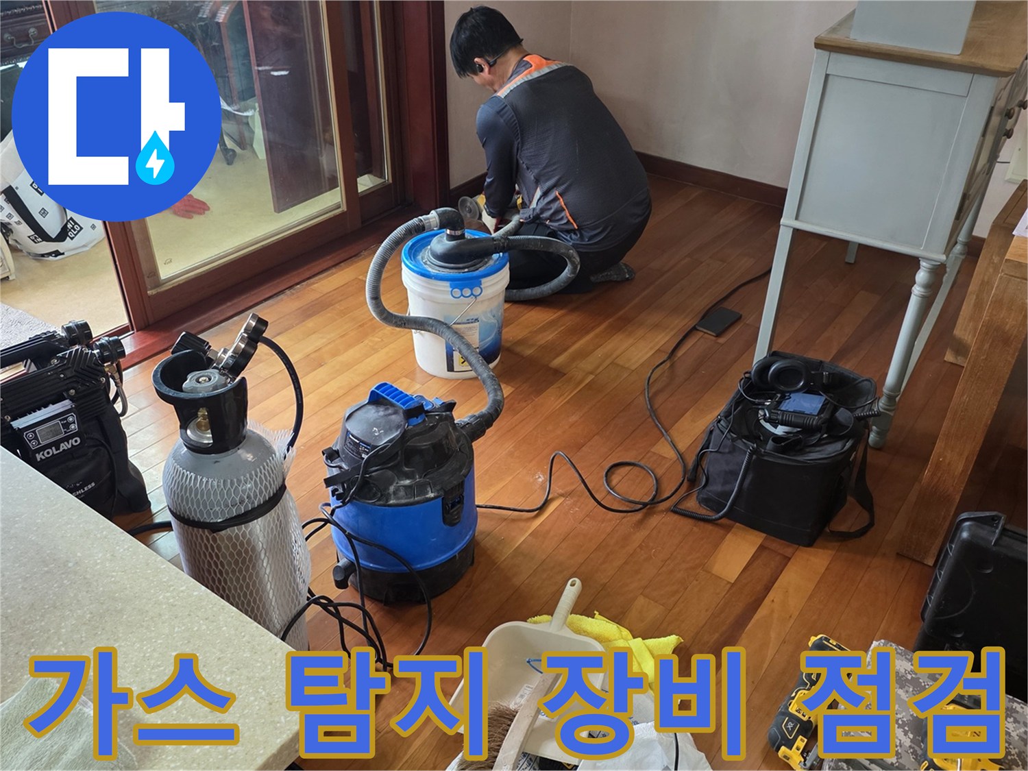 거실 바닥면에서 가스 탐지기를 활용하여 배관 누수 지점을 추적하는 모습