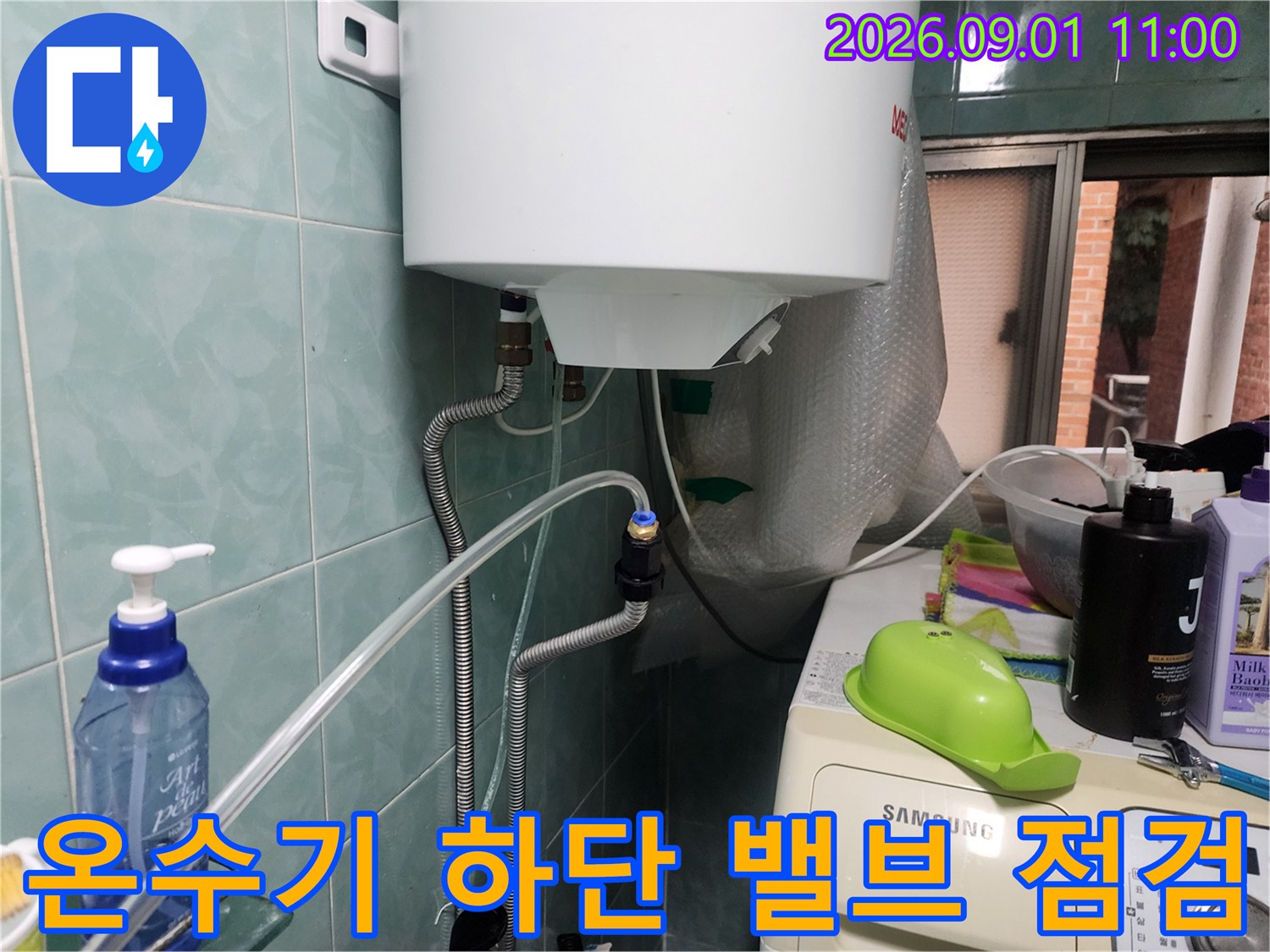 온수기-하단부-금속-배관-및-연결-밸브-점검-중